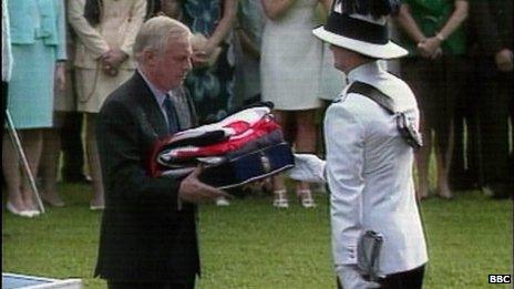 Lord Patten receives the Union Jack flag and Hong Kong Colonial flag as part of the Hong Kong handover ceremony in 1997