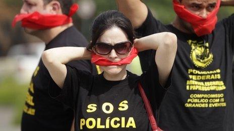 Federal police wear T-shirts that read "SOS Federal Police" in Rio de Janeiro, May 7, 2014.