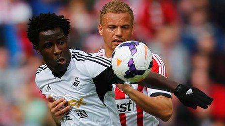 Wilfried Bony takes on Sunderland's Wes Brown