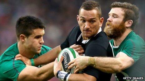 Aaron Cruden of world champions New Zealand is tackled by Conor Murray (L) and Gordon D'Arcy (R) of Ireland