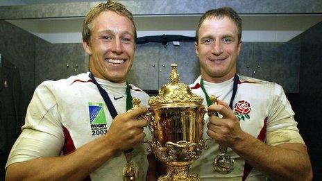 English fly-half Jonny Wilkinson (L) and English fly-half Mike Catt celebrate with the William Webb Ellis Cup after England's win in 2003