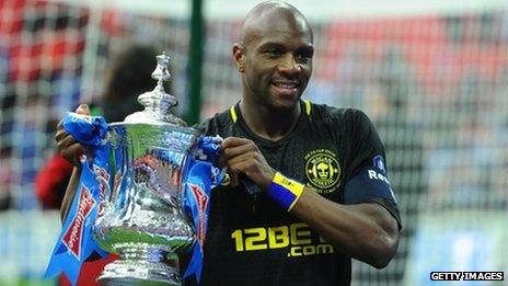 Wigan Athletic's Barbadian defender Emmerson Boyce poses with the FA Cup after beating Man City in the 2013 final