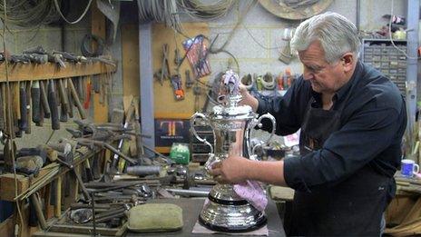 Kevin Williams works on the FA Cup trophy