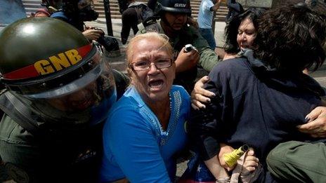 Police detain demonstrators during clashes at an anti-government protest in Caracas, May 14, 2014.