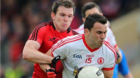 Declan Rooney of Down challenges Tyrone's Kyle Coney