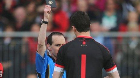 Referee David Coldrick shows a black card to Tyrone keeper Niall Morgan