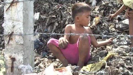 Boy on rubbish heap in Manila