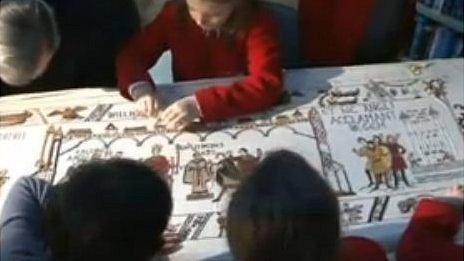 Volunteers working on the final panel of the Bayeux Tapestry created in Alderney