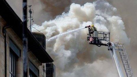 fireman pouring water on Glasgow School of Art