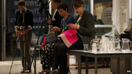 Green Party activists pass the time knitting during the European Parliamentary elections count at London's City Hall