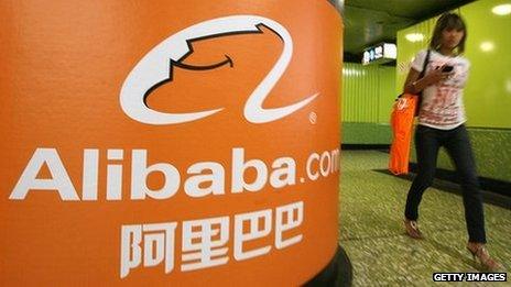 Alibaba.com logo and woman walking