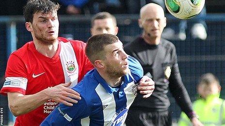 Linfield's Philip Lowry puts pressure on his older brother Stephen