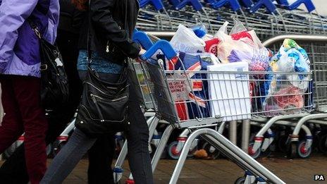 Customers with their shopping leave a Tesco store