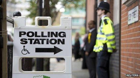 A police officer stands outside a polling station in Tower Hamlets