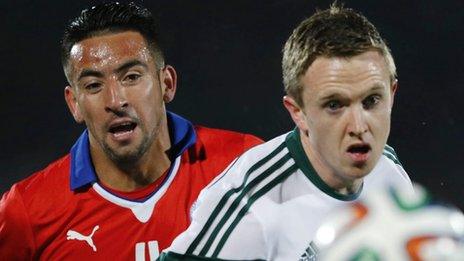 Chile's Mauricio Isla and Shane Ferguson of Northern Ireland