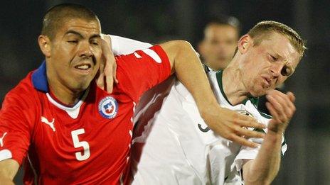 Francisco Silva of Chile competes against Northern Ireland's Billy McKay