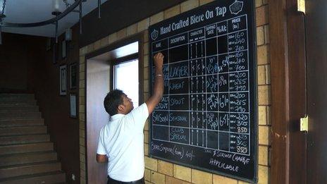 A board showing various craft beers in a pub