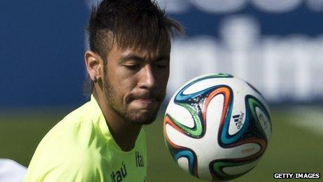 Brazilian national football team player Neymar controls the Adidas Brazuca ball in training