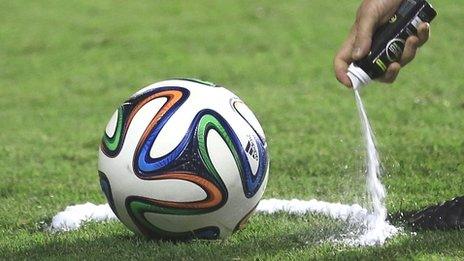 A referee uses vanishing spray during a referee's training session in Rio de Janeiro ahead of the World Cup