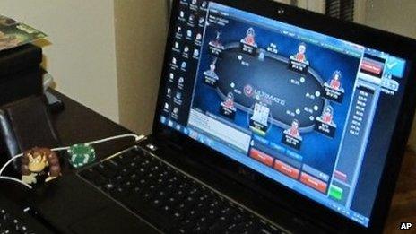 A man playing poker on a laptop computer