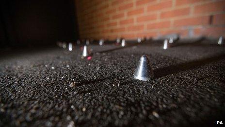 Studs on floor outside block of flats