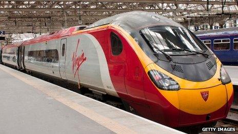 A Virgin Trains Pendolino 390137 sits on platform 2 at Glasgow Central Station