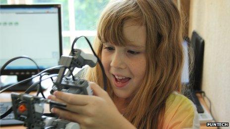 young girl learning robotics