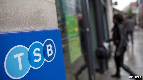 A woman walks into a branch of TSB bank in London