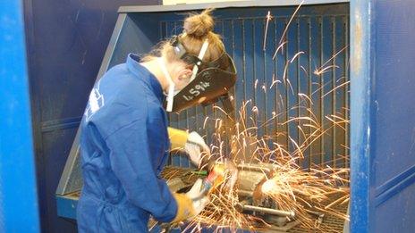 Girl using angle grinder