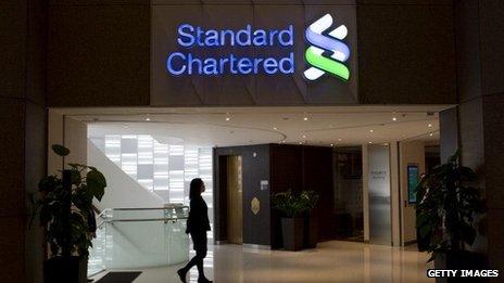 An employee walks through a Standard Chartered bank branch in Hong Kong,