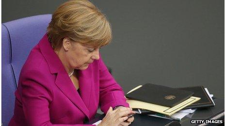 German Chancellor Angela Merkel types on a smartphone