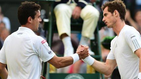 Defending champion Andy Murray shakes hands with Roberto Bautista Agut after Murray's straight-sets win