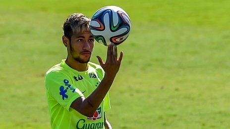 Brazil's Neymar spinning a football on his fingers during training in Belo Horizonte