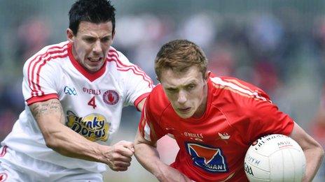 PJ Quinn of Tyrone in action against Louth opponent Ryan Burns