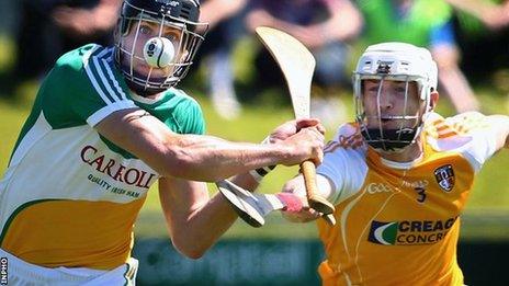 Offaly's Conor Mahon is challenged by Antrim defender Conor McKinley