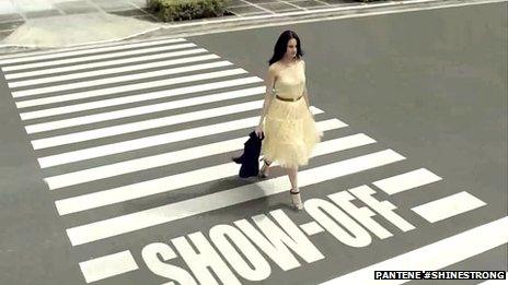 Woman walking across zebra crossing