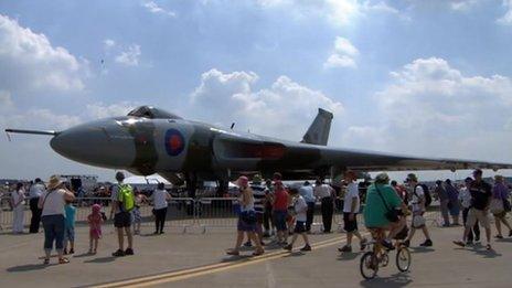 Crowds watch a plane at the air show