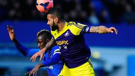 Kyle Bartley challenges for the ball with Lacina Traore