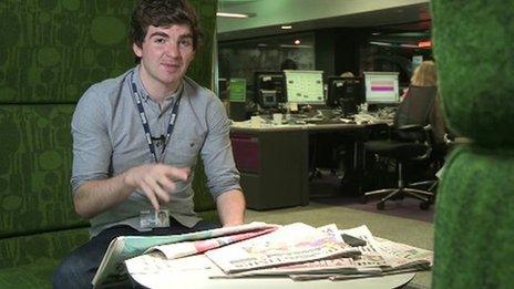 Daniel researching with the newspapers