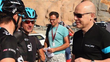 Sir Dave Brailsford talks to two Sky riders