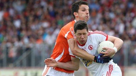 Armagh's Stephen Harold challenges Tyrone skipper Sean Cavanagh