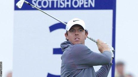 McIlroy watches his tee shot on the third hole on Sunday