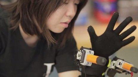 MIT researcher with robotic hand