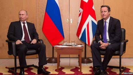 Prime Minister David Cameron sits with Russian President Vladimir Putin at a meeting at Charles De Gaulle Airport in Paris on 5 June 2014