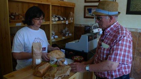 A man buying baked goods in the company shop