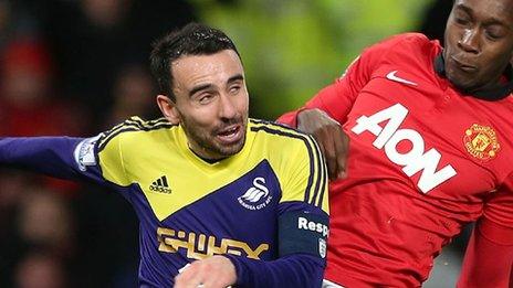 Swansea City's Leon Britton in action against Manchester United's Danny Wellbeck