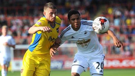 Swansea City's Jefferson Montero battles for the ball against Exeter City