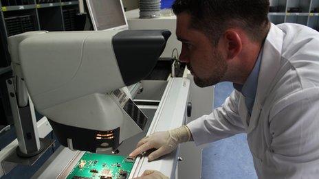 man inspecting a chip board