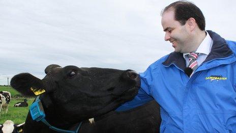 Dr Harty smiling at a cow