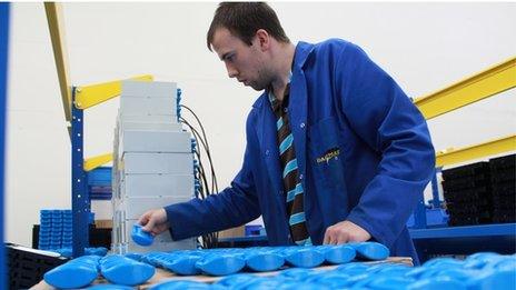 A worker checking the blue plastic "moo monitors"